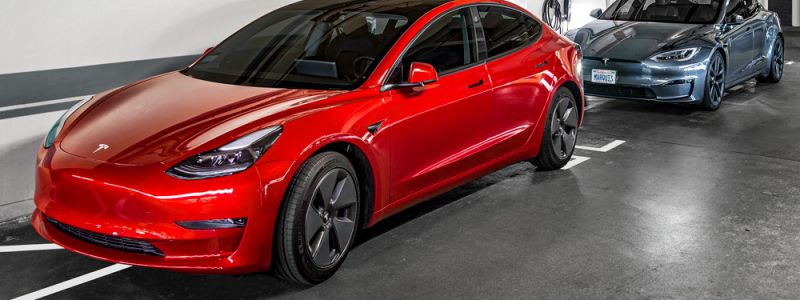 A TESLA plugged into a charging station at the Sunset Marquis in their Electric Vehicle garage.