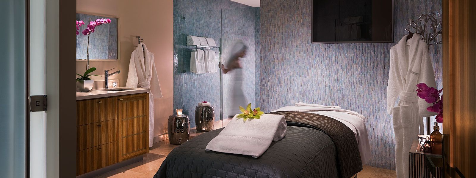 A person entering the private shower in the luxury treatment rooms featuring Porsche massage tables at the Sunset Marquis in West Hollywood.
